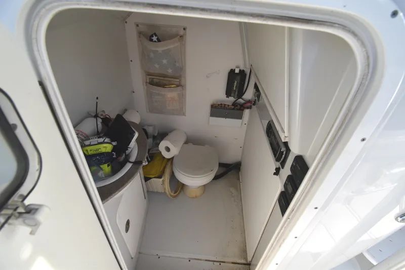 Slide: The Image of Interior of 2007 Glacier Bay 3065 Canyon Runner boat bathroom with toilet and sink. - 32