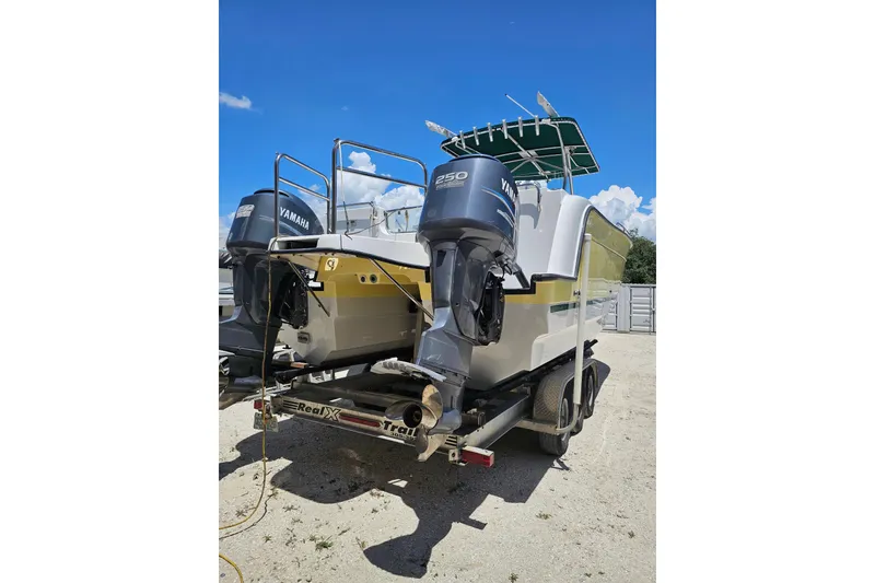 Slide: The Image of 2007 Glacier Bay 3065 Canyon Runner boat with dual Yamaha engines on a trailer. - 4