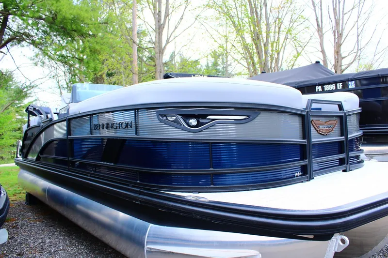 The Image of 2026 Bennington 24 MFBSF pontoon boat with sleek design, parked outdoors. - 0