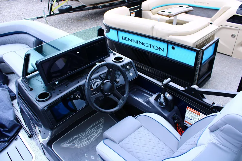 Slide: The Image of 2026 Bennington 24 MFBSF boat interior with modern steering console and seating. - 13