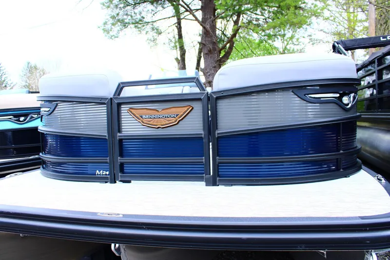 Slide: The Image of 2026 Bennington 24 MFBSF pontoon boat with sleek blue and gray design. - 2