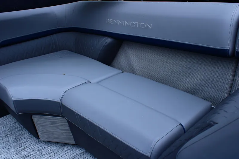 Slide: The Image of Luxurious seating in the 2026 Bennington 24 MFBSF boat, featuring sleek gray upholstery. - 4
