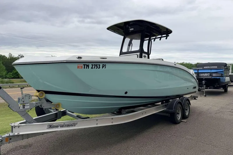The Image of 2023 Yamaha Boats 255 FSH Sport E on trailer, parked outdoors. - 0