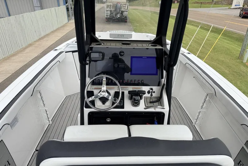 Slide: The Image of 2023 Yamaha Boats 255 FSH Sport E dashboard with steering wheel and controls. - 8