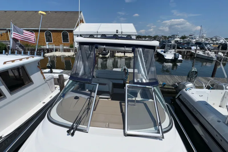 Slide: The Image of 2017 Regal 28 Express boat docked at a marina with clear skies. - 1