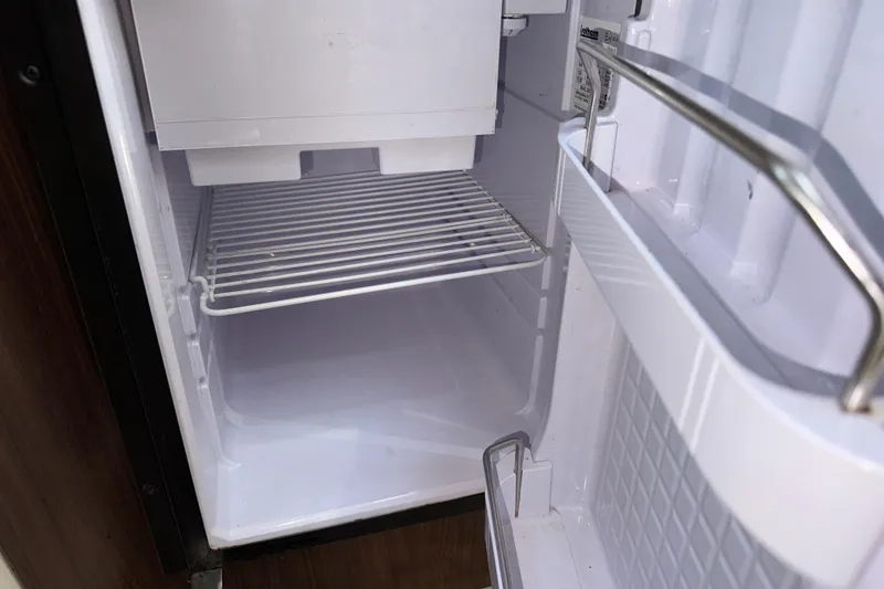 Slide: The Image of Empty refrigerator interior in a 2017 Regal 28 Express boat. - 10