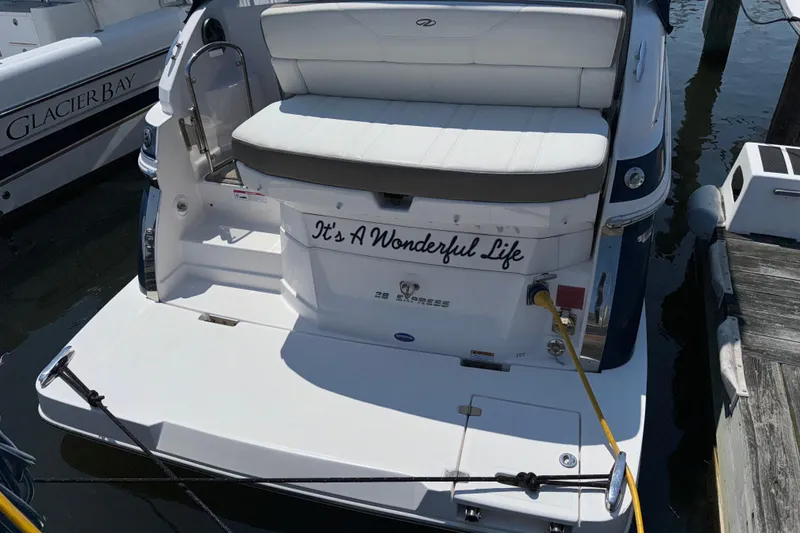 Slide: The Image of 2017 Regal 28 Express boat docked, featuring "It's A Wonderful Life" text on the stern. - 16