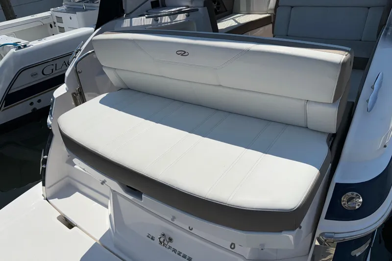 Slide: The Image of White seating on a 2017 Regal 28 Express boat, docked in sunlight. - 18