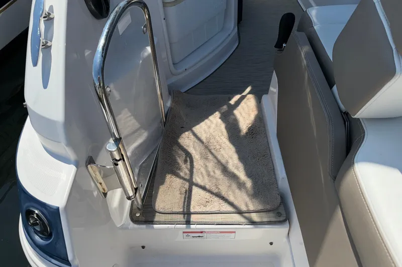 Slide: The Image of 2017 Regal 28 Express boat interior with seating and entry gate. - 19