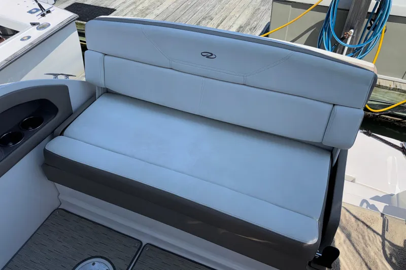 Slide: The Image of 2017 Regal 28 Express boat seat with cup holders, docked at marina. - 20