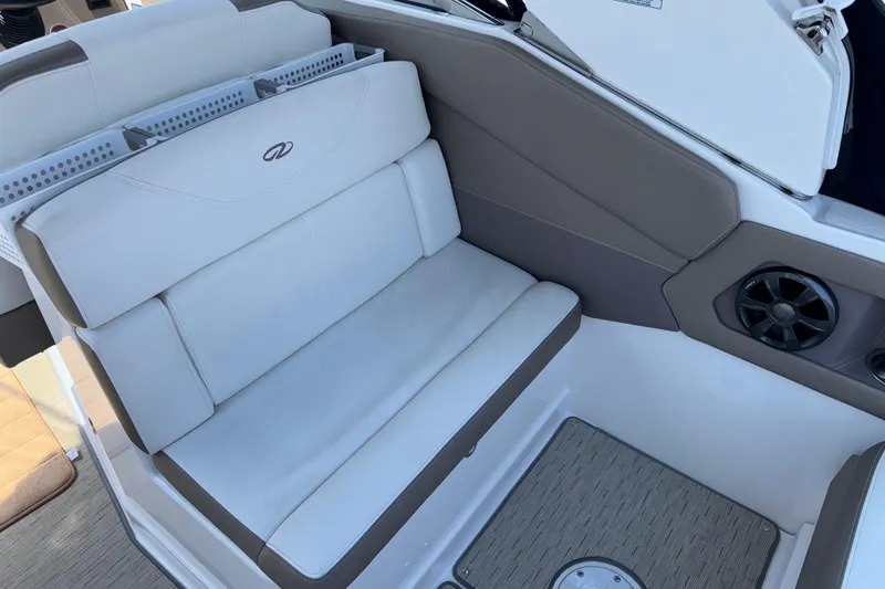 Slide: The Image of 2017 Regal 28 Express boat interior seating with speaker and storage compartments. - 22