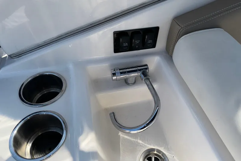 Slide: The Image of Interior of 2017 Regal 28 Express boat with faucet and cup holders. - 24