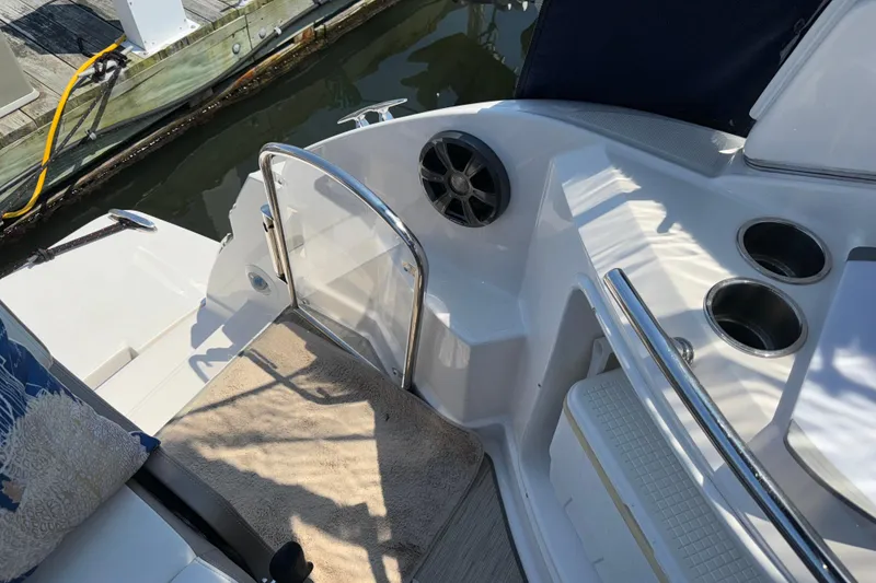 Slide: The Image of 2017 Regal 28 Express boat interior with speaker, cup holders, and dock view. - 27