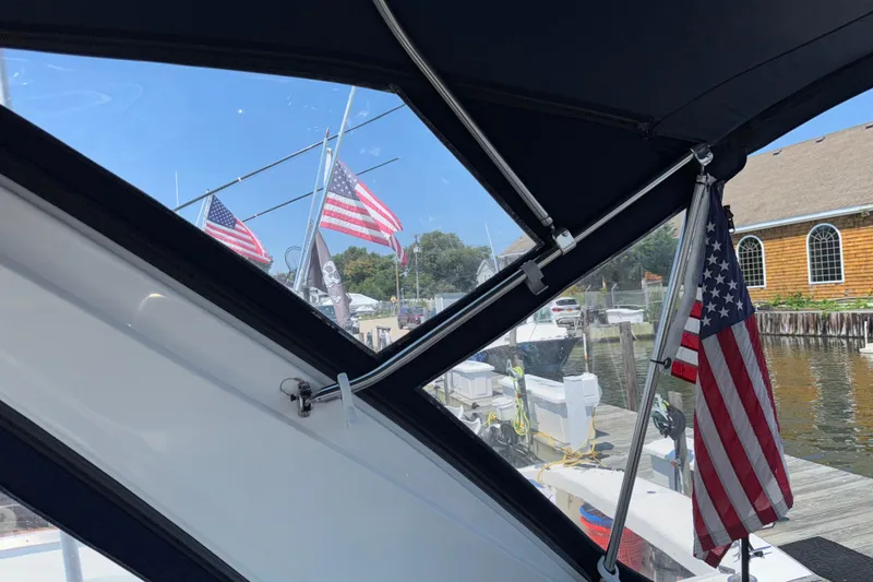 Slide: The Image of Interior view from a 2017 Regal 28 Express boat, showcasing American flags dockside. - 29