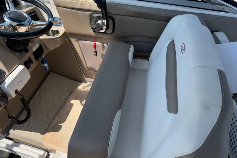 Slide: The Image of Interior of a 2017 Regal 28 Express boat with steering wheel and seating. - 30
