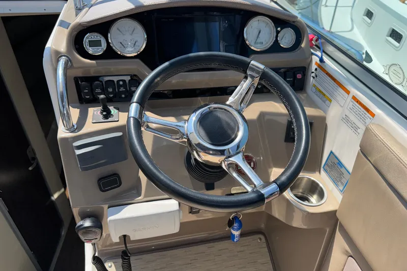 Slide: The Image of Steering wheel and dashboard of a 2017 Regal 28 Express boat cockpit. - 31
