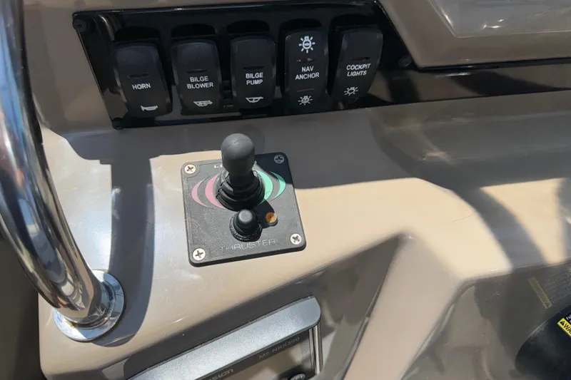 Slide: The Image of Control panel of a 2017 Regal 28 Express boat with joystick and switches. - 37