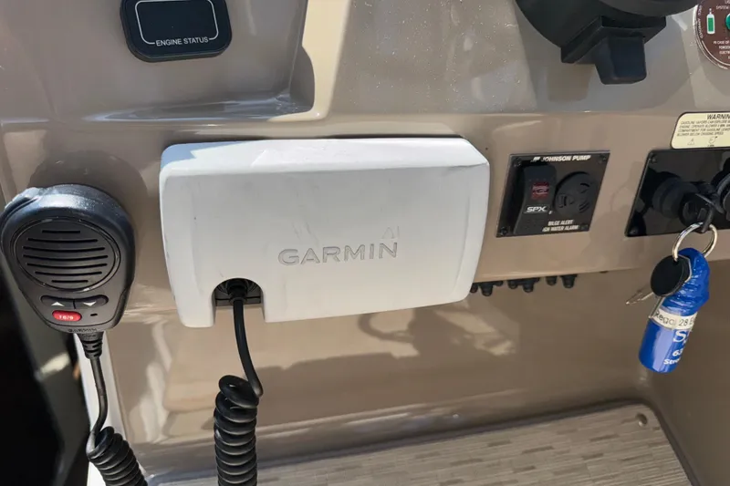 Slide: The Image of Control panel of a 2017 Regal 28 Express boat with Garmin device and keys. - 39