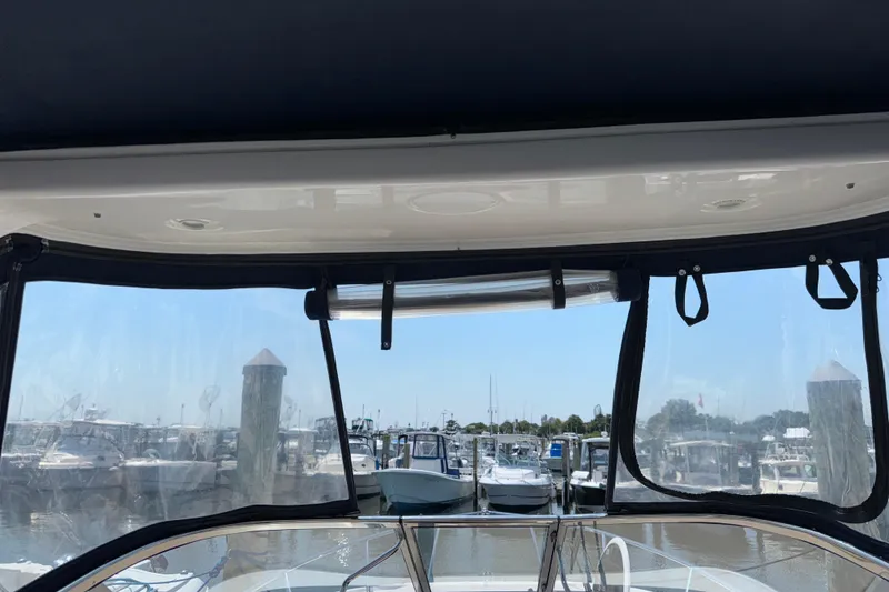 Slide: The Image of Interior view from a 2017 Regal 28 Express boat, overlooking a marina. - 42