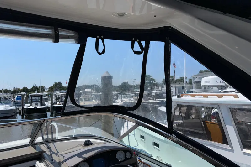 Slide: The Image of Interior view of a 2017 Regal 28 Express boat at a marina. - 43