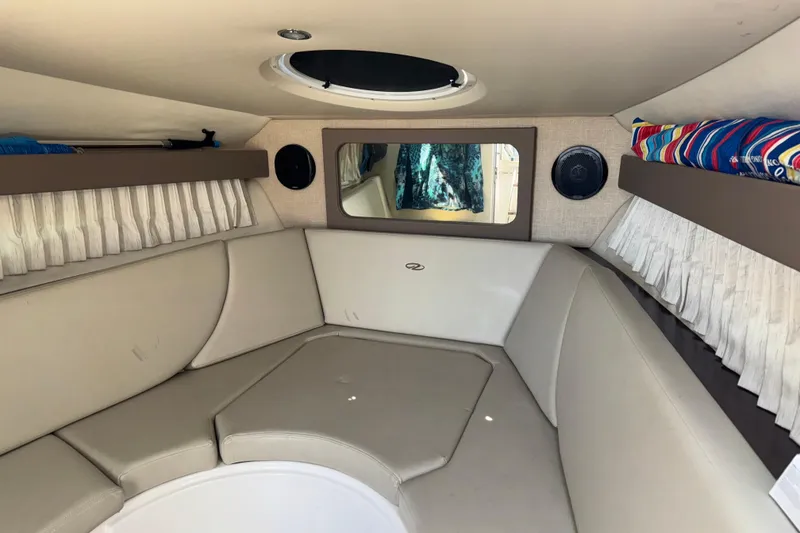 Slide: The Image of Interior cabin of 2017 Regal 28 Express boat with beige seating and porthole. - 44