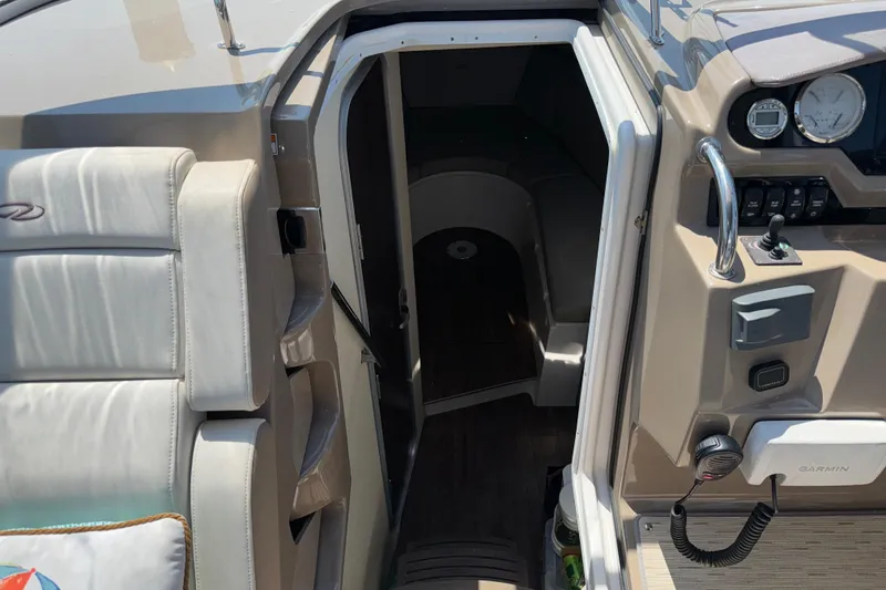 Slide: The Image of 2017 Regal 28 Express boat interior with helm and cabin entrance. - 45