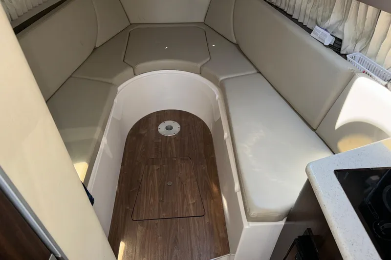 Slide: The Image of Interior cabin of 2017 Regal 28 Express boat with beige seating and wood flooring. - 46