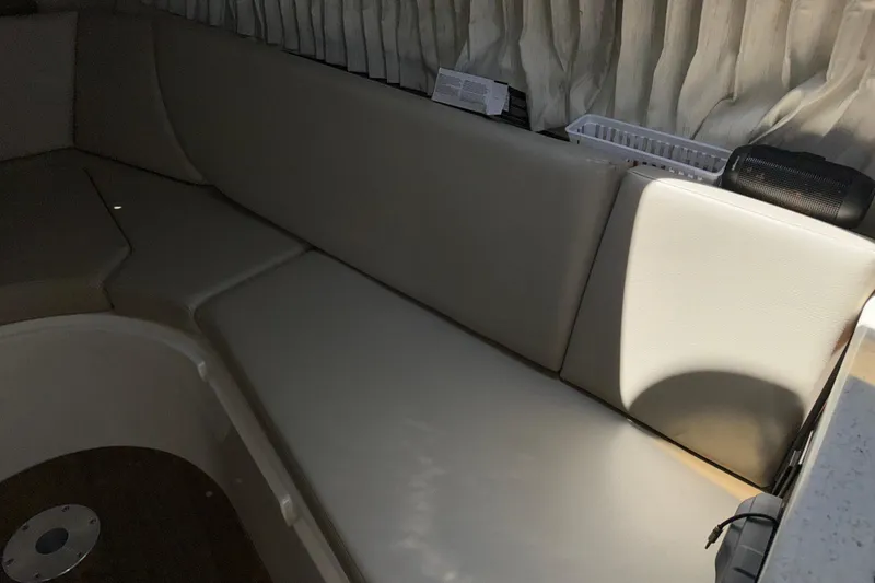 Slide: The Image of Interior seating area of a 2017 Regal 28 Express boat with beige upholstery. - 47