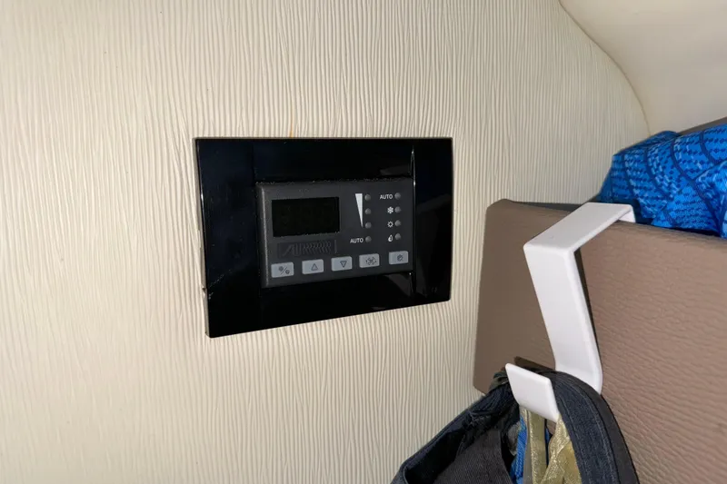 Slide: The Image of Control panel inside a 2017 Regal 28 Express boat cabin. - 52