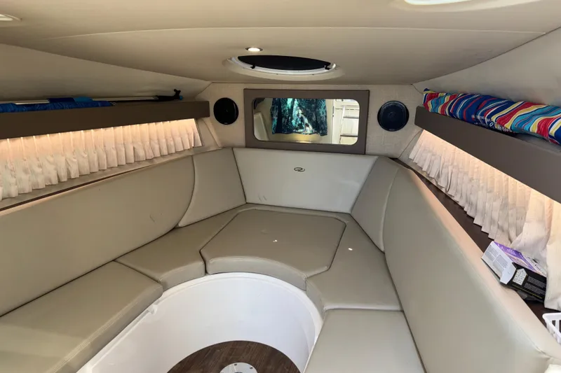 Slide: The Image of Interior of 2017 Regal 28 Express boat with beige seating and colorful accents. - 53