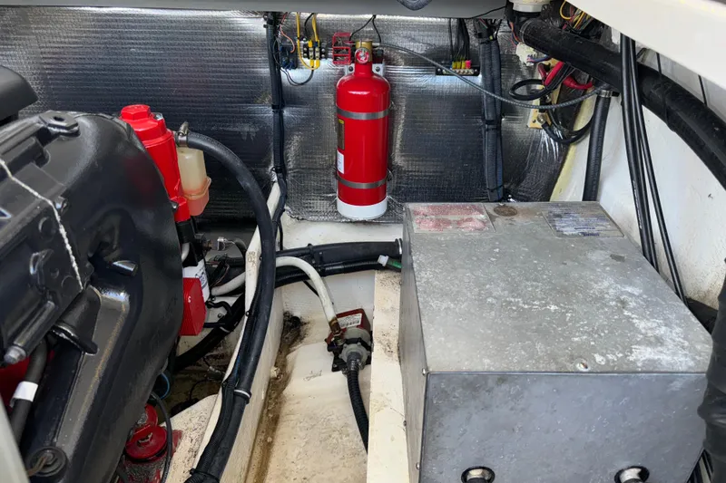 Slide: The Image of Engine compartment of a 2017 Regal 28 Express boat with fire extinguisher and wiring. - 56