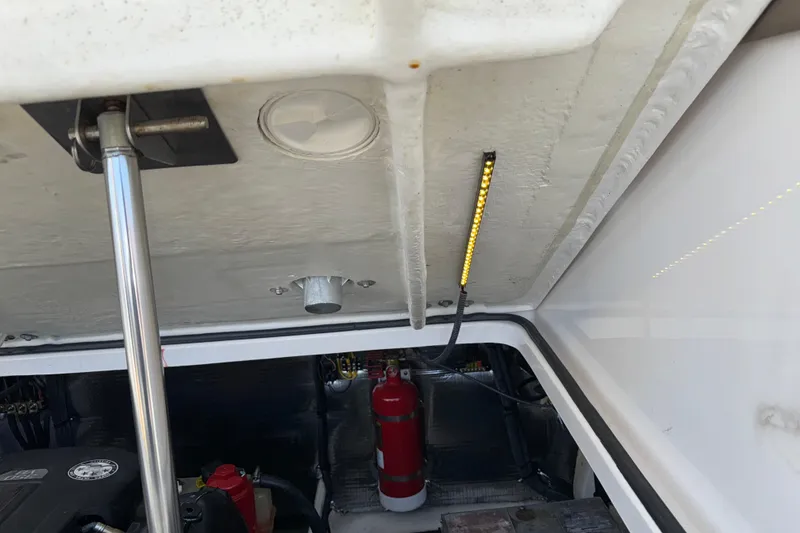 Slide: The Image of Engine compartment of a 2017 Regal 28 Express boat with visible fire extinguisher. - 57