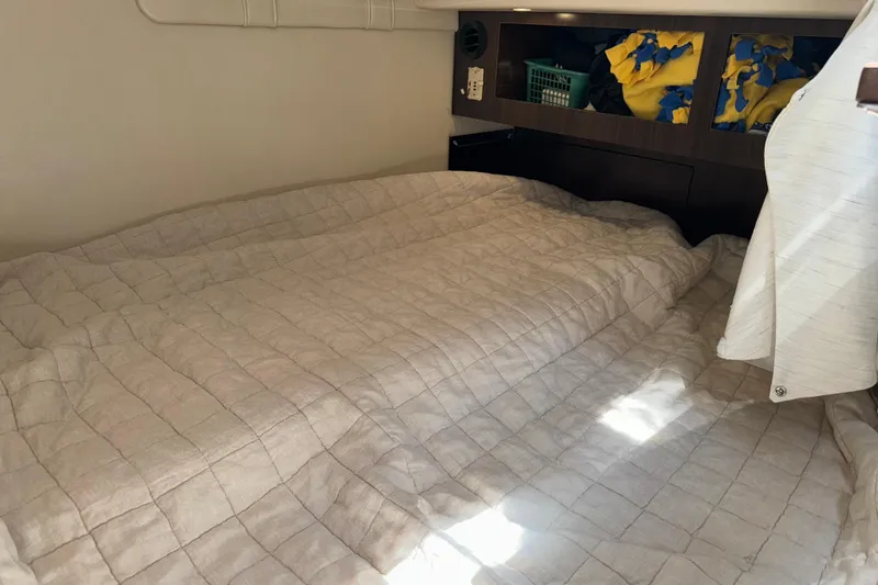 Slide: The Image of Cozy cabin interior of 2017 Regal 28 Express boat with bed and storage. - 6