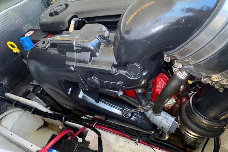 Slide: The Image of Engine compartment of a 2017 Regal 28 Express boat, showcasing mechanical components. - 60