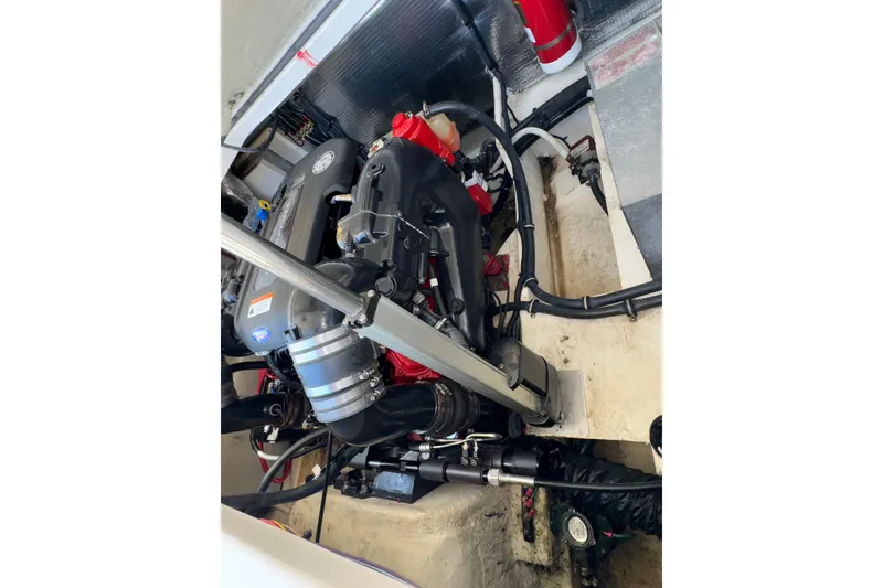 Slide: The Image of Engine compartment of a 2017 Regal 28 Express boat, showcasing mechanical components. - 61