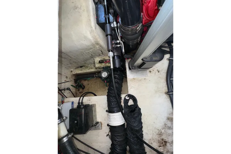 Slide: The Image of Engine compartment of a 2017 Regal 28 Express boat, showing hoses and mechanical components. - 62