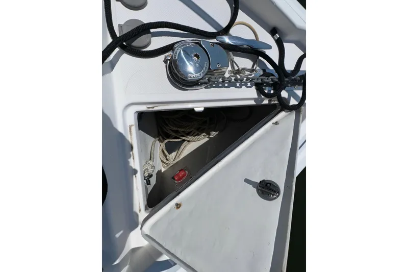 Slide: The Image of Open anchor locker on a 2017 Regal 28 Express boat, showing ropes and chain. - 65