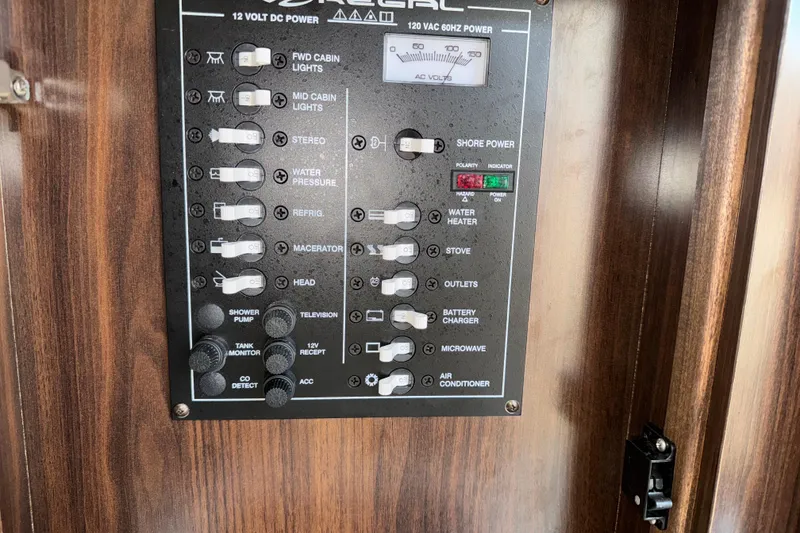 Slide: The Image of Control panel of a 2017 Regal 28 Express boat with various switches and indicators. - 8