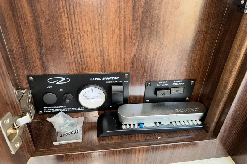Slide: The Image of Control panel inside a 2017 Regal 28 Express boat, featuring level monitor and antenna switches. - 9