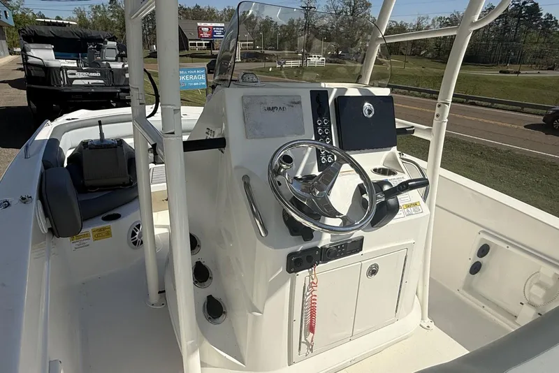 Slide: The Image of 2023 NauticStar 211 Hybrid boat console with steering wheel and controls. - 6