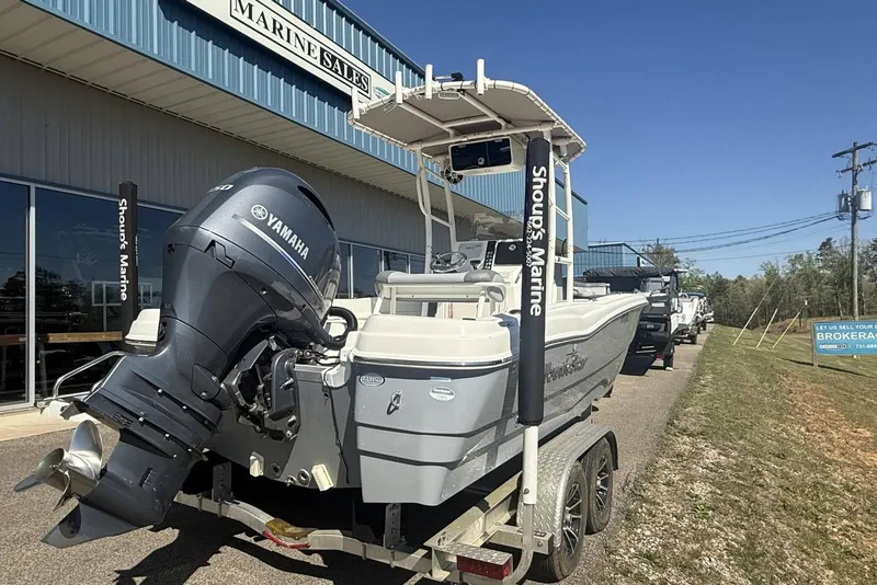 Slide: The Image of 2023 NauticStar 211 Hybrid boat with Yamaha engine at marine sales dealership. - 7