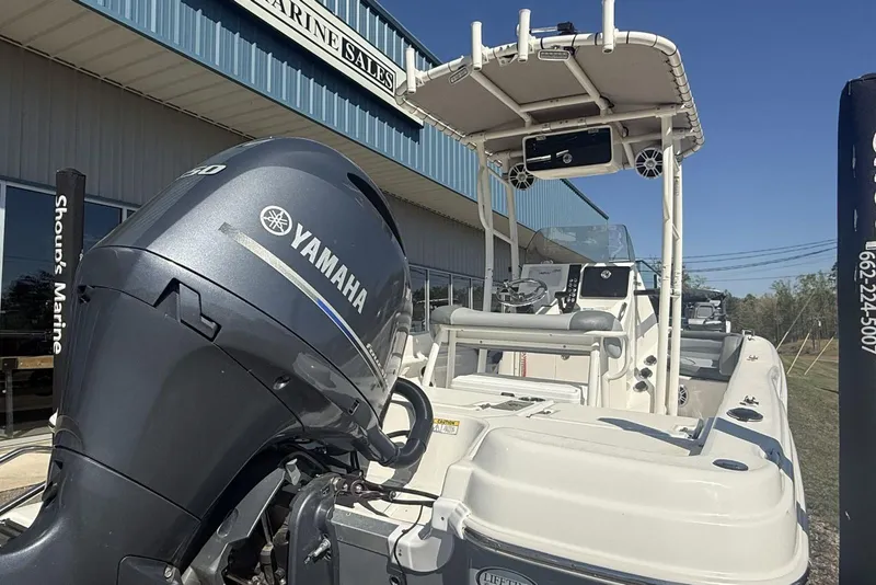 Slide: The Image of 2023 NauticStar 211 Hybrid boat with Yamaha engine at marine sales location. - 9