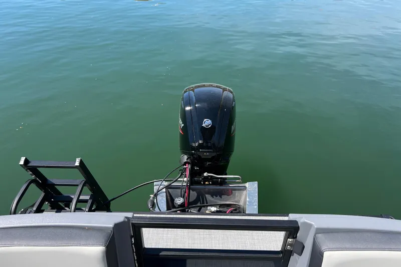 Slide: The Image of 2026 Starcraft GX 22 R DH boat with outboard motor on calm water. - 14