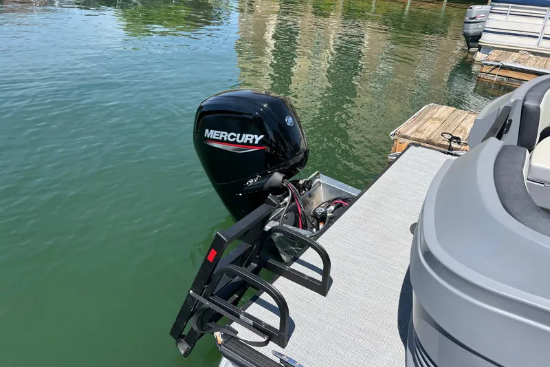 Slide: The Image of Starcraft GX 22 R DH 2026 boat with Mercury outboard motor docked on water. - 2