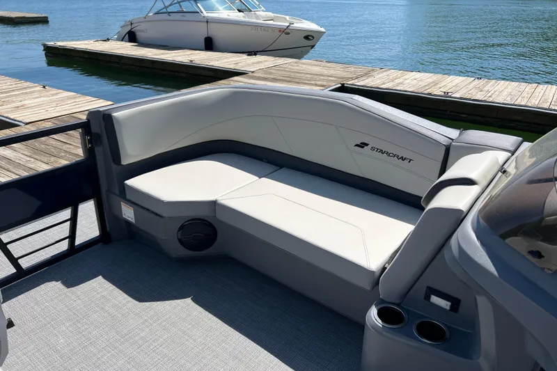 Slide: The Image of 2026 Starcraft GX 22 R DH boat interior with sleek seating at a dock. - 4