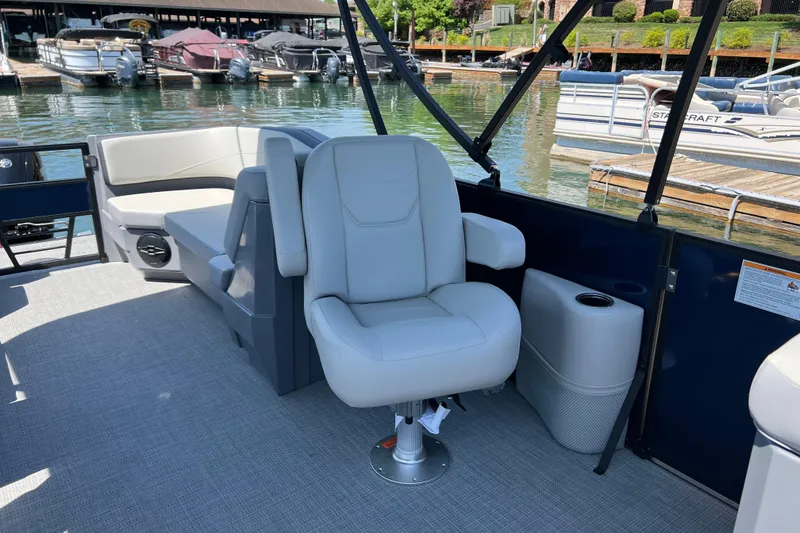 Slide: The Image of 2026 Starcraft GX 22 R DH boat interior with comfortable seating at a marina. - 6