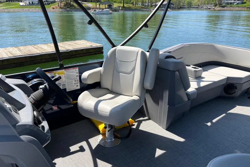 Slide: The Image of 2026 Starcraft GX 22 R DH boat interior with helm seat and lake view. - 7