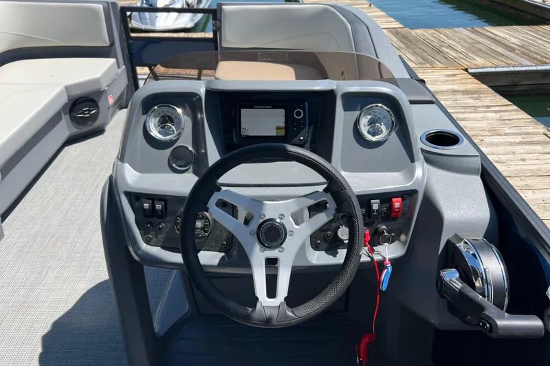 Slide: The Image of Steering console of 2026 Starcraft GX 22 R DH boat, featuring modern controls and gauges. - 9