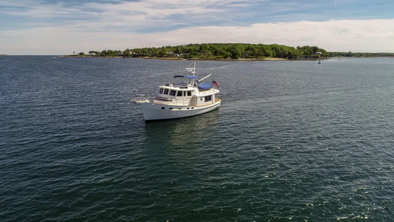 Slide: The Image of 2009 Kadey-Krogen 44 yacht on calm waters near an island. - 1