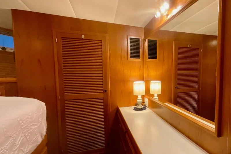 Slide: The Image of Cozy 2009 Kadey-Krogen yacht cabin with wooden paneling, mirror, and soft lighting. - 11